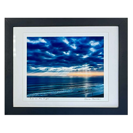 ECC Live in the Light Print with Frame by Photographer Claire Closson.  A majestic print of an original photograph.  Framed and under glass at 11x 14inches.  Brooding clouds reflected on dark waters.  God's Light breaking through the clouds.  Cannot be shipped.  Local pick up in Mount Dora, Florida.  