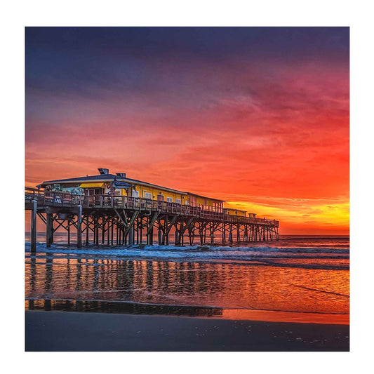 ECC “Neon Orange Sunrise” Matted Print by Photographer Claire Closson.  Famed Crabby Joe's Seafood on the Sunglow Pier in Daytona Beach Shores, Florida. Neon orange , brilliant yellows and purple skies are reflected in the ocean.  A beautiful photorgaph for any home. 12 x 16 matted and ready to be framed.