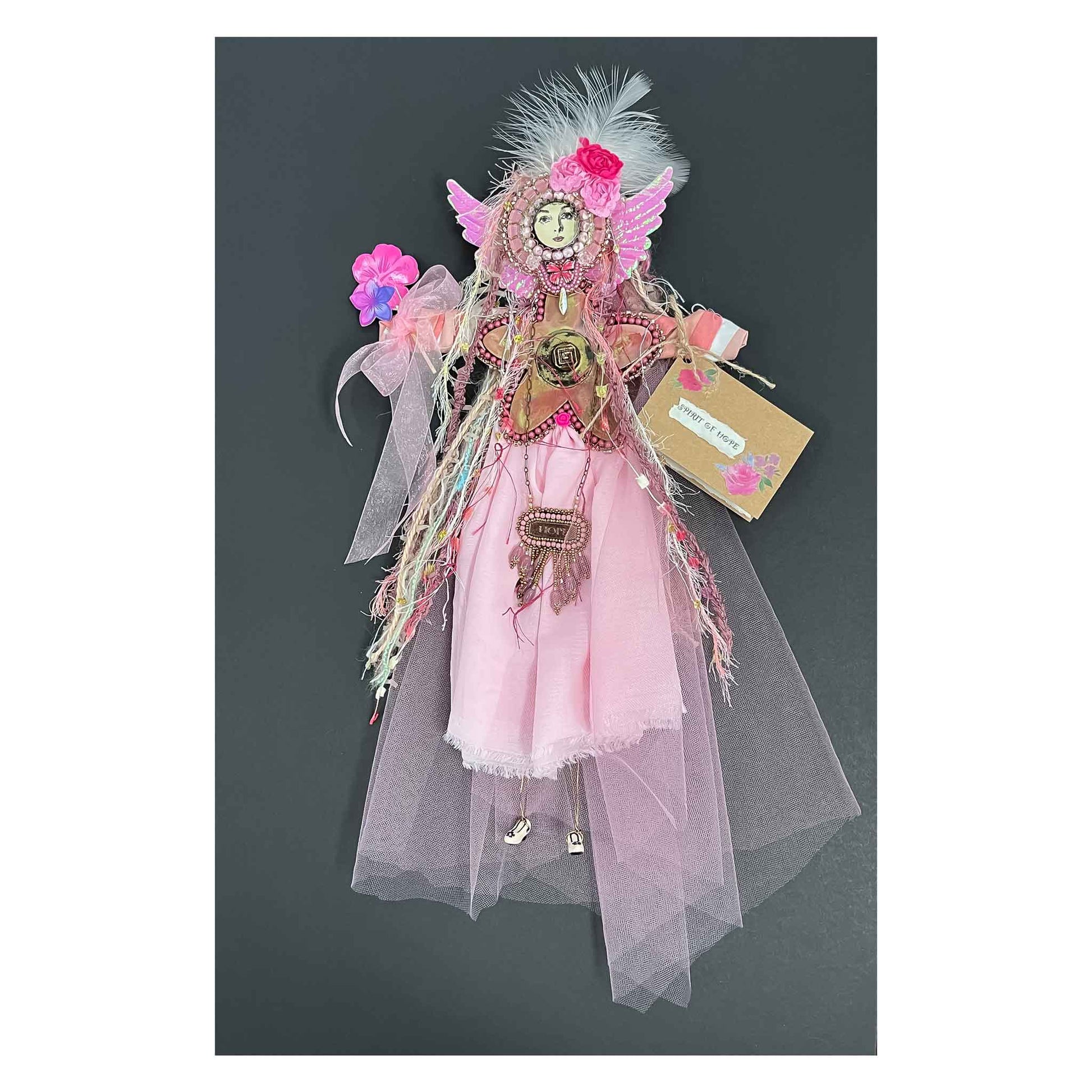 Doll, Spirit of Hope,  pink chiffon,  bead embroidery, encaustic, painted wood, ceramic shoes, flowers, a butterfly. a necklace, wings, wire, fabric, yarn, feathers, 16 X 9