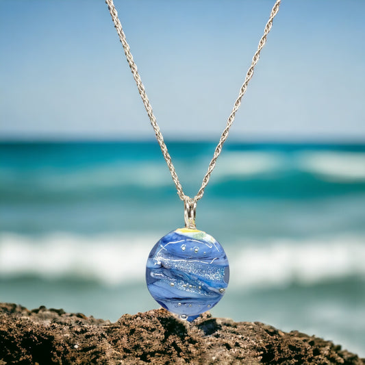 JSK Blue Waves Lampwork Pendant by Glass Artist June Knowles.  A stunning glass bead with ribbons of blue and white throughout.  Focal bead and bail is 1.25 inches and sterling chain is 18 inches in length.  A perfect statement for anyone who loves blue. 