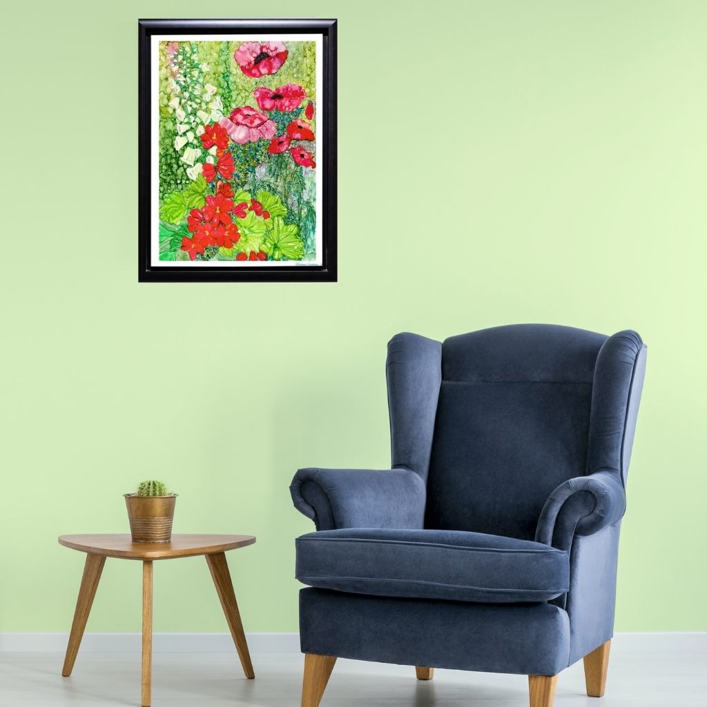 a black framed Cottage Garden Poppy Print in a light green room with a blue chair