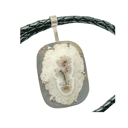 An unusual solar quartz stone mounted on a sterling silver flat pendant