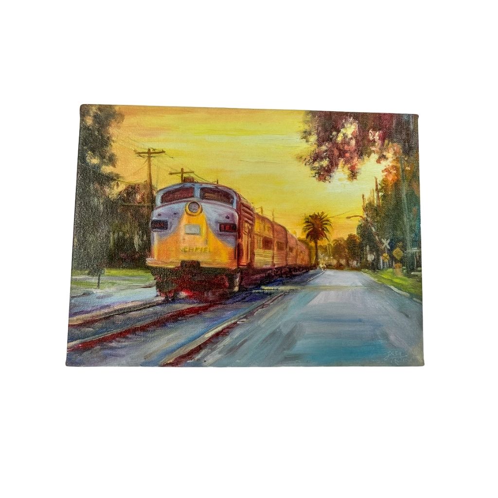 Sunset Train.  Full view of canvas with road and trees and railroad crossing next to the train on the tracks.l  Painting of an old train at sunset. Sky is yellow, train is blue and yellow with red on the cars.